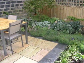 slate edging to paving patio outdoor dining ideas lush groundcover planting euphorbia brunnera acer