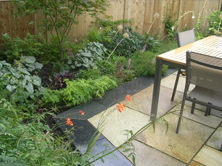 slate edging to paving patio outdoor dining ideas lush groundcover planting euphorbia brunnera