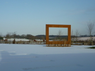 orange rust steel frame sculpture in snow open countryside view in Wetherby yorkshire contemporary garden design