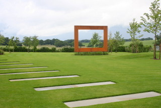 steel frame sculpture in large yorkshire garden with stepping stone paving through lawn countryside view through frame contemporary garden design