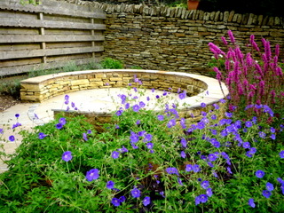 stone circular seating area with sandstone paving circle and dry stone garden wall yorkshire