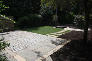 yorkshire sandstone paving steps through lawn with patio of sandstone and granite setts contemporary garden design