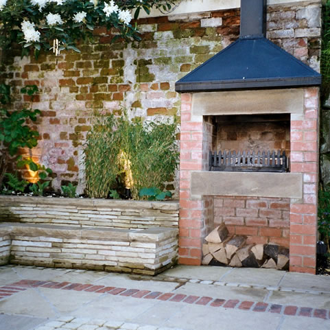 courtyard garden landscaping with built in seating brick outdoor oven wood store  at Otley Yorkshire